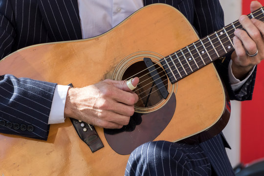 Wooden guitar in musician hands