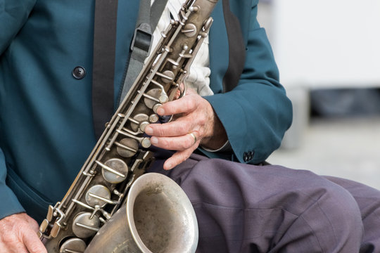 Saxophone in the hands of a street musician