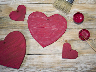 colored wooden hearts in a rustic wood background