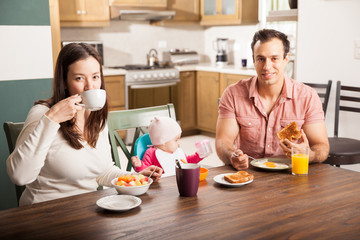 Hispanic family enjoying breakfast at home
