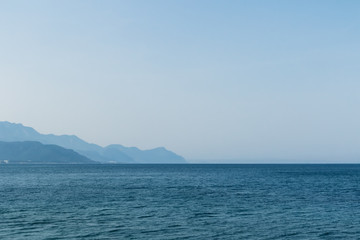 Fototapeta na wymiar Sea on the background of mountains and sky