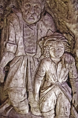 The wooden figure of a man with a child