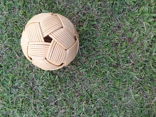 Rattan ball, takraw ball on green grass