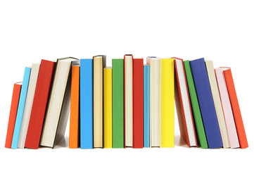 Row line of colorful books isolated on white background school college library bookshelf photo