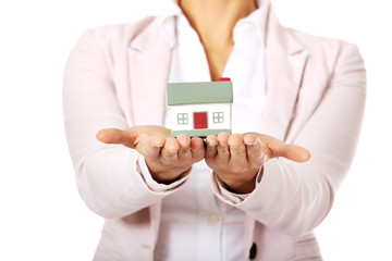 Business woman holding a house model