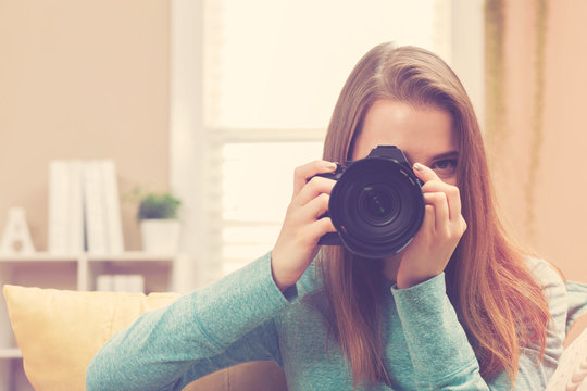Young female photographer with DSLR camera