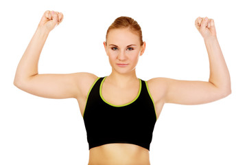 Young athletic woman showing muscles