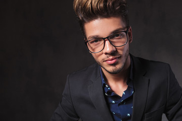 Obraz premium fashionable smart man wearing glasses in dark studio