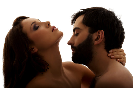 Caucasian man kissing woman's neck.