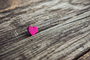A wooden heart on a blackboard