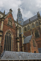 Fototapeta na wymiar The bell tower of the Grote Kerk (Sint-Bavokerk) in the histori