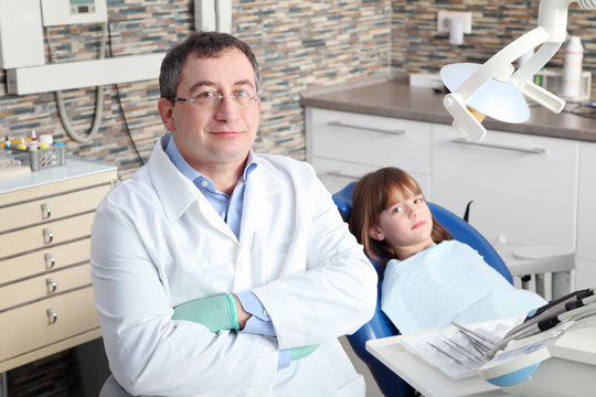 Male dentist and young patient