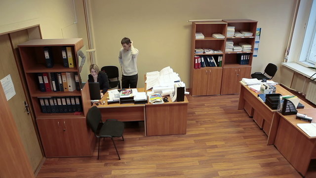 Coworkers talking together in office room, engineering department, man and woman, timelapse

