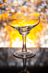 Whiskey glass empty on the background bokeh bright colors.