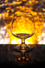 Whiskey glass empty on the background bokeh bright colors.