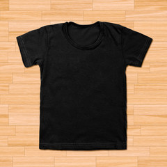 Black blank t-shirt on wooden background