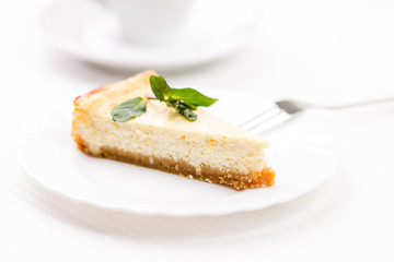 Piece of cheesecake on white saucer