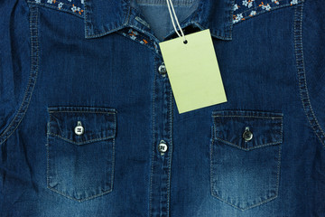 Blue jean shirt with empty tag for background. Can use for marketing your product background.