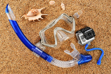 Fototapeta na wymiar Scuba mask and snorkel on the sand. Action camera.