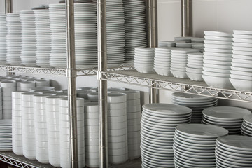 many white plates on a wire rack