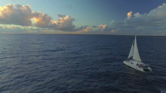 Sailboat cruise on caribbean sea at sunset