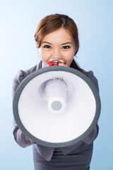 Businesswoman shouting with loudspeaker
