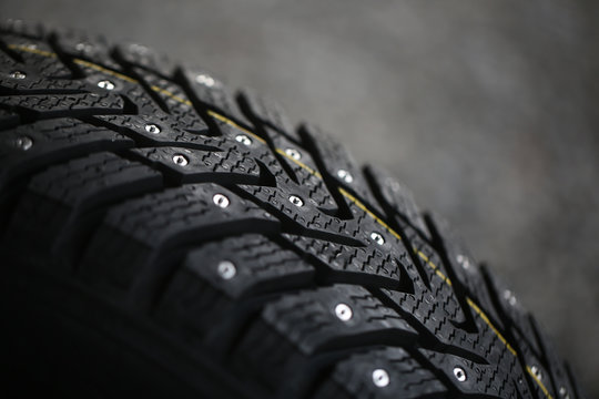 Studded Tire On A Gray Background