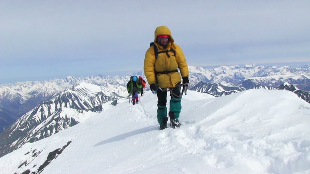 ALTAI , RUSSIA-MAY 2015: Iiktoo mountain, South Chui range, altitude 4000 m. Climber rises on a steep mountain snow slope. 
