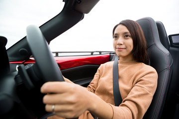 Young woman driving cabriolet