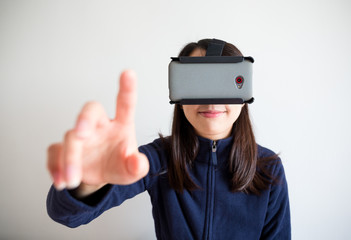 Woman look though vr device and touch on air
