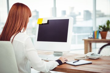 Hipster businesswoman using her computer