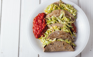 Vegan tacos on white wooden background