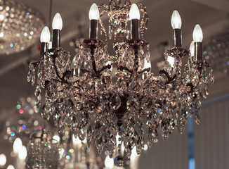 Brass chandelier with crystal. Lighted chandelier with crystal pendants. 
