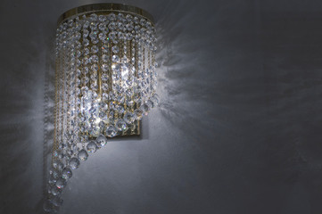 Brass sconces with crystal. Lighted sconces with crystal pendants. 