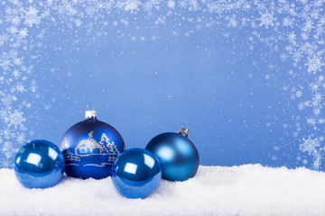 Blue Christmas balls in the snow