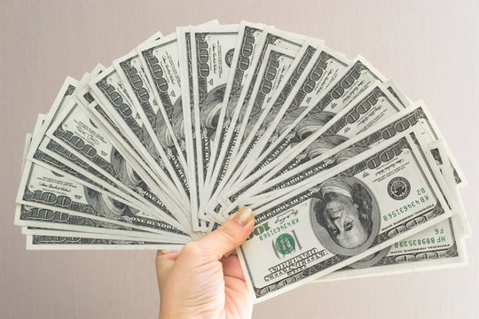 Woman hand with dollars isolated on a white background