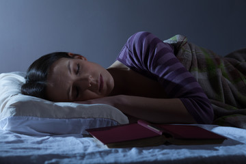 Young woman is sleeping in her bed