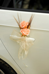 White car decorated with a bouquet of flowers for a wedding
