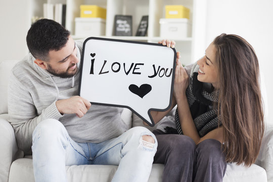 Young Couple Showing Love Message Written On White Board. I Love You Message. Valentines Couple,shallow Depth Of Filed