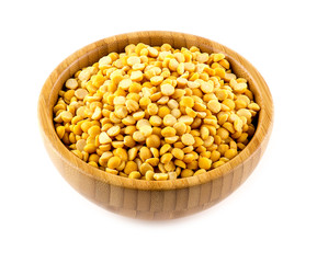 Split yellow lentils in bowl studio isolated