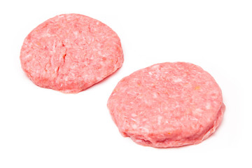 Raw crocodile meat burgers isolated on a white studio background