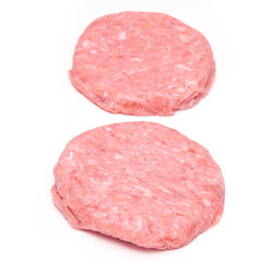 Raw crocodile meat burgers isolated on a white studio background