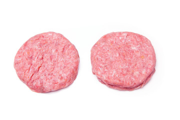 Raw crocodile meat burgers isolated on a white studio background