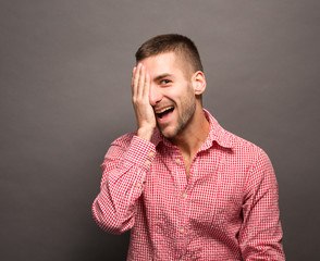 Man covering eyes his face