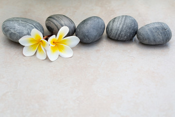 Fototapeta na wymiar Plumeria flower and stones for spa background