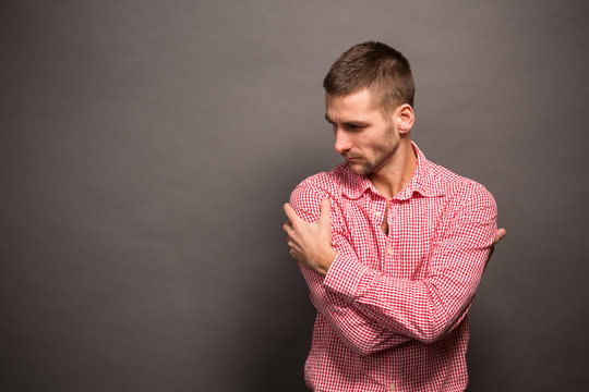 Man Hugging Himself In Studio