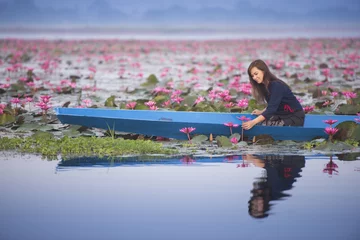 Fotobehang Lotusbloem beautiful young woman Farmer collecting pink lotus in garden. thai lifestyle people in local,Thailand  © thekob5123