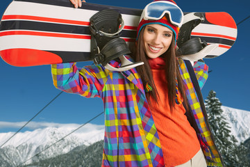 Female snowboarder on top of the mountain