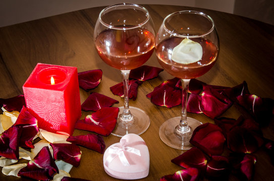 Celebration event - Valentine's Day - Wine, candles, and red petal roses on table