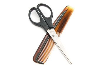 plastic comb and scissors on white